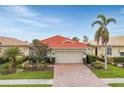 Single story home with red tile roof, two car garage and nicely landscaped yard at 150 Mestre Pl, North Venice, FL 34275