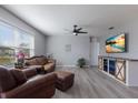 Living room with brown leather furniture and farmhouse-style media console at 15404 Trinity Fall Way, Bradenton, FL 34212