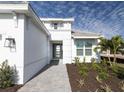 Landscaped front yard with walkway leading to house entrance at 16415 Isola Pl, Bradenton, FL 34211