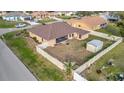 Backyard view of a house with a storage shed and fenced-in yard at 23039 Worth Ave, Port Charlotte, FL 33954