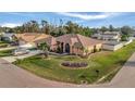 Single-Gathering home with a spacious yard, palm trees, and a two-car garage at 23039 Worth Ave, Port Charlotte, FL 33954