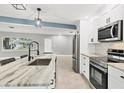 Modern kitchen featuring stainless steel appliances and granite countertops at 2430 Sunnyside Ln, Sarasota, FL 34239