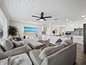 Open living area with gray sectional sofa and large TV at 2586 Tami Sola St, Sarasota, FL 34237