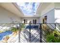 Small courtyard with a yellow door, blue tile, and potted plants at 327 Hernando Ave, Sarasota, FL 34243