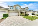 Two-story townhome with inviting front porch and landscaped lawn at 3640 Tin Cup Blvd, Sarasota, FL 34232