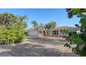 Charming house with a brick driveway and lush landscaping at 3858 Casey Key, Nokomis, FL 34275