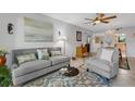 Living room with gray couch, chair, and glass-top coffee table at 3981 Maceachen Blvd # 322, Sarasota, FL 34233