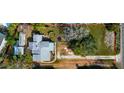 Aerial view of a house and two vacant lots with surrounding trees at 4420 102Nd W St, Bradenton, FL 34210