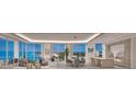 Open concept living space with panoramic water views and modern furnishings at 555 Quay Cmn # 1105, Sarasota, FL 34236