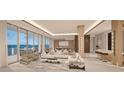 Spacious living room with water views and modern furniture at 555 Quay Cmn # Ph2002, Sarasota, FL 34236