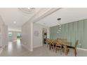 Dining area with wooden table and chairs, view into living room at 5755 Woodland Sage Dr, Sarasota, FL 34238