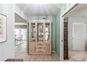 Bright entryway with built-in curio cabinet and view to dining area at 610 Estuary Dr # 610, Bradenton, FL 34209