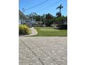 Backyard with putting green, paver patio, and canal view at 618 Jungle Queen Way, Longboat Key, FL 34228