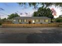 Charming house exterior at dusk with a wooden fence at 710 31St N Ave, St Petersburg, FL 33704