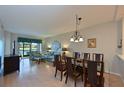 Bright living room with dining area, view to backyard, and hardwood floors at 1003 Fairwaycove Ln # 101, Bradenton, FL 34212