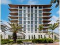 Modern building exterior with palm trees at 111 Golden Gate Pt # 401, Sarasota, FL 34236