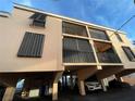 Exterior view of a beach condo showing parking underneath and balconies at 117 10Th N St # 122, Bradenton Beach, FL 34217