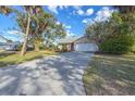 House exterior with a long driveway and palm trees at 1204 W 20Th Ave, Palmetto, FL 34221