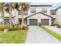 Two-story townhome with gray double garage doors and landscaped front yard at 15127 Lyla Ter, Bradenton, FL 34211