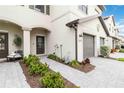 Townhome entry with walkway, landscaping, and gray garage door at 15127 Lyla Ter, Bradenton, FL 34211