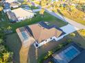 Aerial view showcasing a house with a pool and a large backyard in a residential neighborhood at 17250 Lake Worth Blvd, Port Charlotte, FL 33948