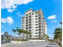 Luxury high rise building with paved courtyard and tropical landscaping at 2050 Benjamin Franklin Dr # B304, Sarasota, FL 34236