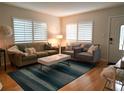 Bright living room with hardwood floors, comfy sofas, and a stylish coffee table at 210 Briggs Ct, Sarasota, FL 34237