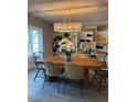 Dining area with built-in shelving and a wood table at 2510 Parma St, Sarasota, FL 34231
