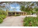 Charming single story home with a spacious driveway and mature trees at 2885 Arrowhead Rd, Venice, FL 34293