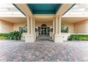 Elegant condo building entrance with columns and a teal covered walkway at 3080 Grand Bay Blvd # 544, Longboat Key, FL 34228