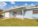 Light blue house with a white garage door and a covered porch at 3231 Yorktown St, Sarasota, FL 34231