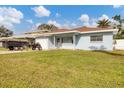 House with a green lawn, white garage, and light blue exterior at 3231 Yorktown St, Sarasota, FL 34231