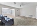 Spacious living room featuring a blue couch and tile floor at 3231 Yorktown St, Sarasota, FL 34231