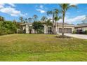 Single-story house with palm trees and a large grassy yard at 3506 Culpepper Ter, North Port, FL 34286