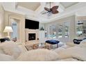 Spacious living room with fireplace, large TV, and pool view at 3843 E 59 Avenue Cir, Ellenton, FL 34222