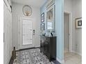 Bright and spacious entryway with patterned floor and barn door at 3922 Wildgrass Pl, Parrish, FL 34219