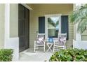 Inviting front porch with rocking chairs, perfect for relaxing at 3922 Wildgrass Pl, Parrish, FL 34219