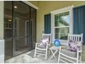 Screened porch with rocking chairs and view of the front yard at 3922 Wildgrass Pl, Parrish, FL 34219