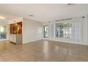 Spacious living room with tile flooring and access to other rooms at 418 Sarabay Rd, Osprey, FL 34229