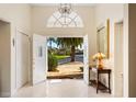 Bright entryway with open doors revealing a view of the landscaped front yard at 4512 Spring Flower Ct, Sarasota, FL 34233