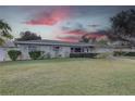 Landscaped lawn and single story home with a light gray exterior at 5117 6Th Avenue W Dr, Bradenton, FL 34209