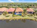 Aerial view showcasing homes with pools, situated by a lake at 5133 Cantabria Crst, Sarasota, FL 34238