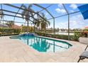 Relaxing screened-in pool and spa with lake view at 5133 Cantabria Crst, Sarasota, FL 34238