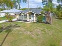 Single-story green house with landscaped yard at 5375 Joslyn Ter, Port Charlotte, FL 33981