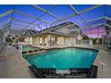 Inviting pool area with spa and screened enclosure at 6170 Misty Oaks Dr, Sarasota, FL 34243