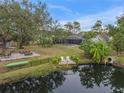 Spacious backyard with pool, dock, and lush landscaping at 6207 93Rd Street E Cir, Bradenton, FL 34202