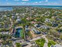 Aerial view of waterfront property with large lot and tennis court at 624 Norsota Way, Sarasota, FL 34242