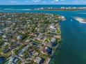 Aerial view of waterfront property with large lot and tennis court at 624 Norsota Way, Sarasota, FL 34242