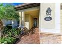 Front entry with brick walkway, stone accents, and a stylish door at 6512 Willowshire Way, Bradenton, FL 34212