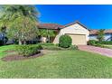 Single-story house with tile roof, landscaping, and paver driveway at 6512 Willowshire Way, Bradenton, FL 34212